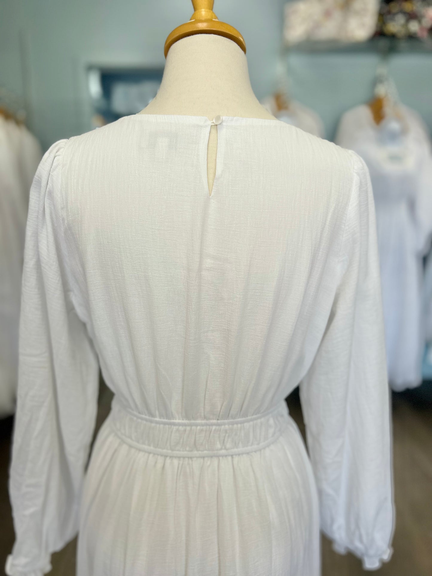 White dress with button whole closure.