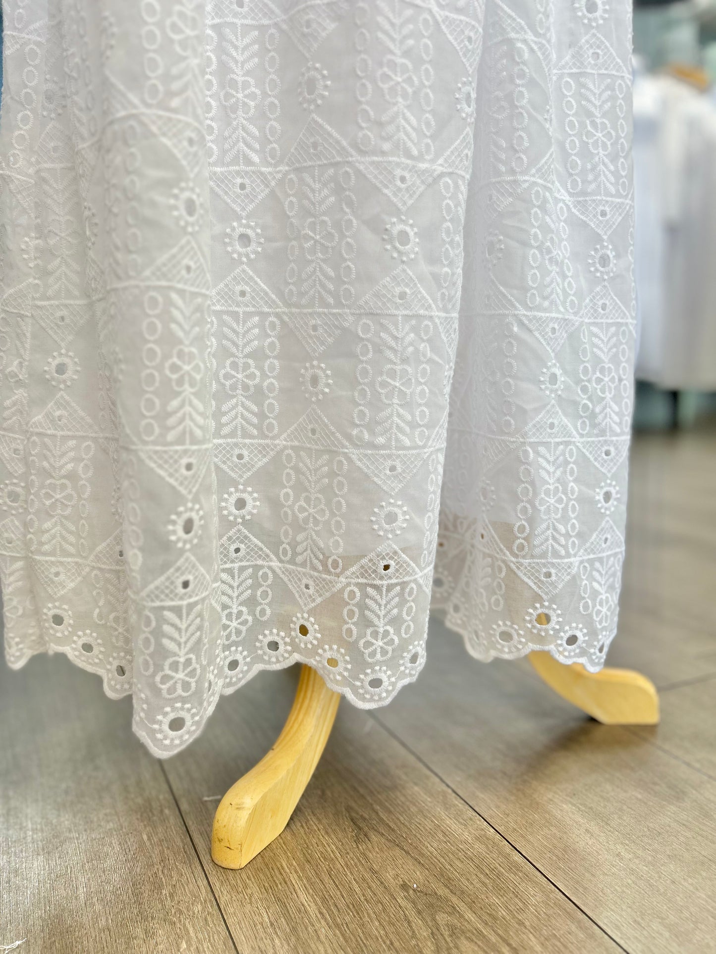 White eyelet dress with scalloped hem.