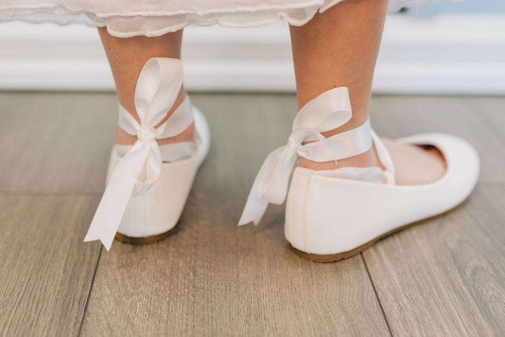 white ballerina flats with ribbon tie