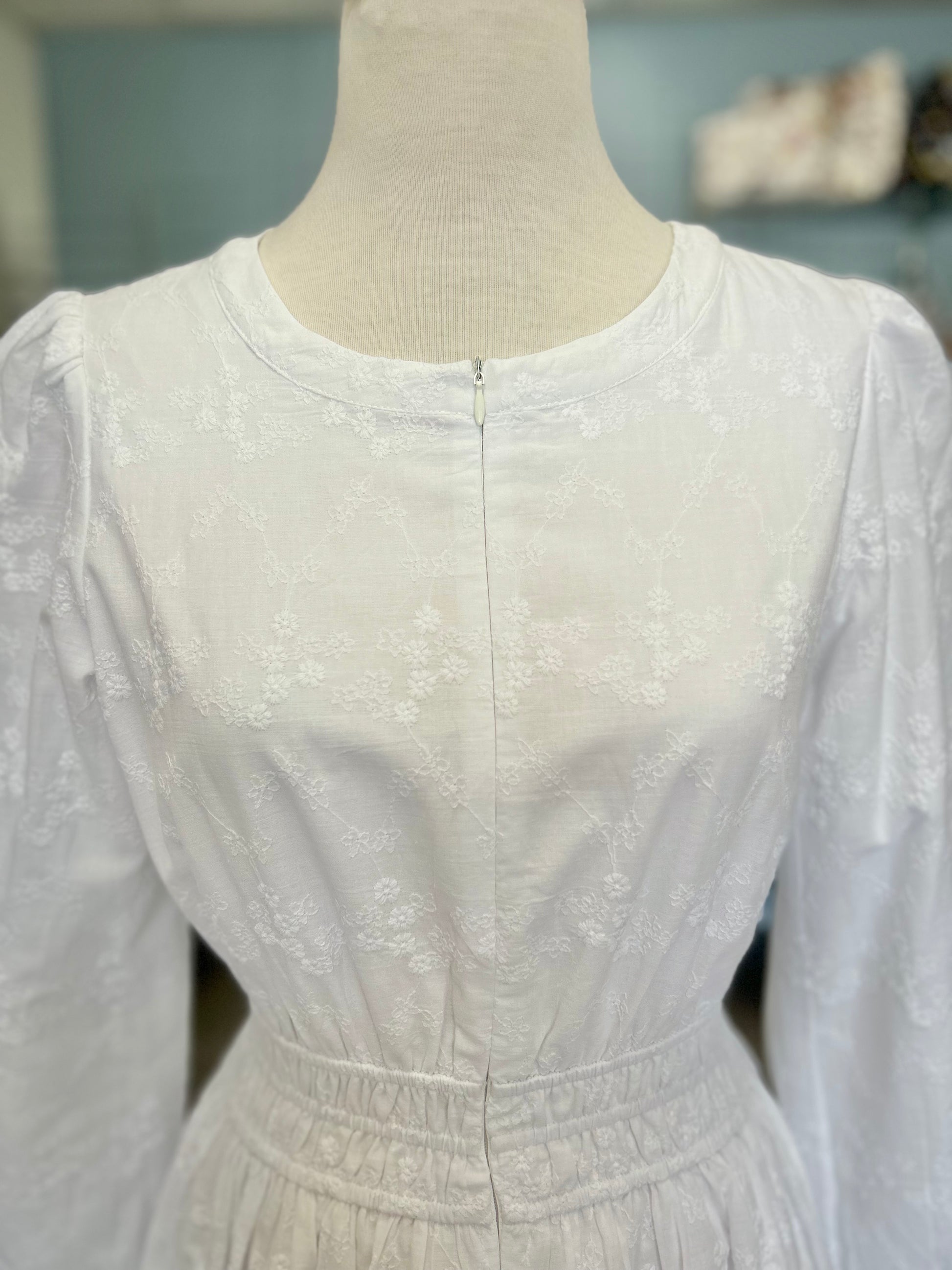 White zip front dress with embroiderey design.