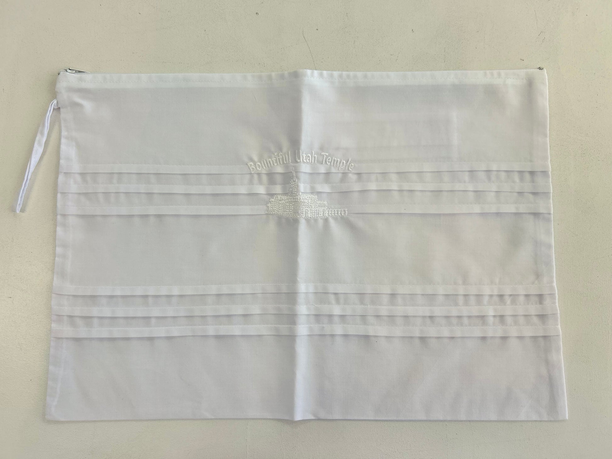 White cotton envelope with embroidery.