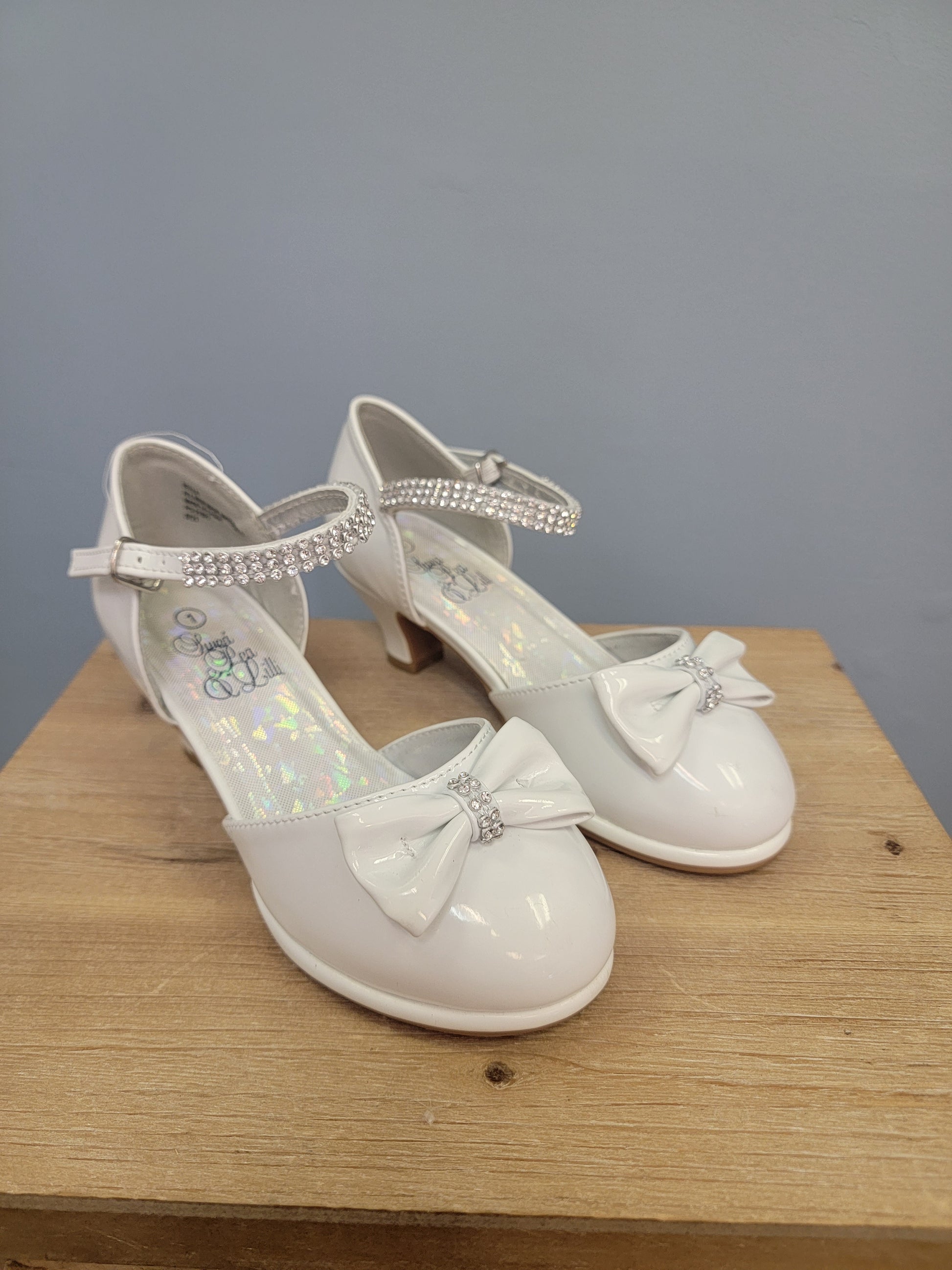 white girls shoe with ankle strap and bow on toe