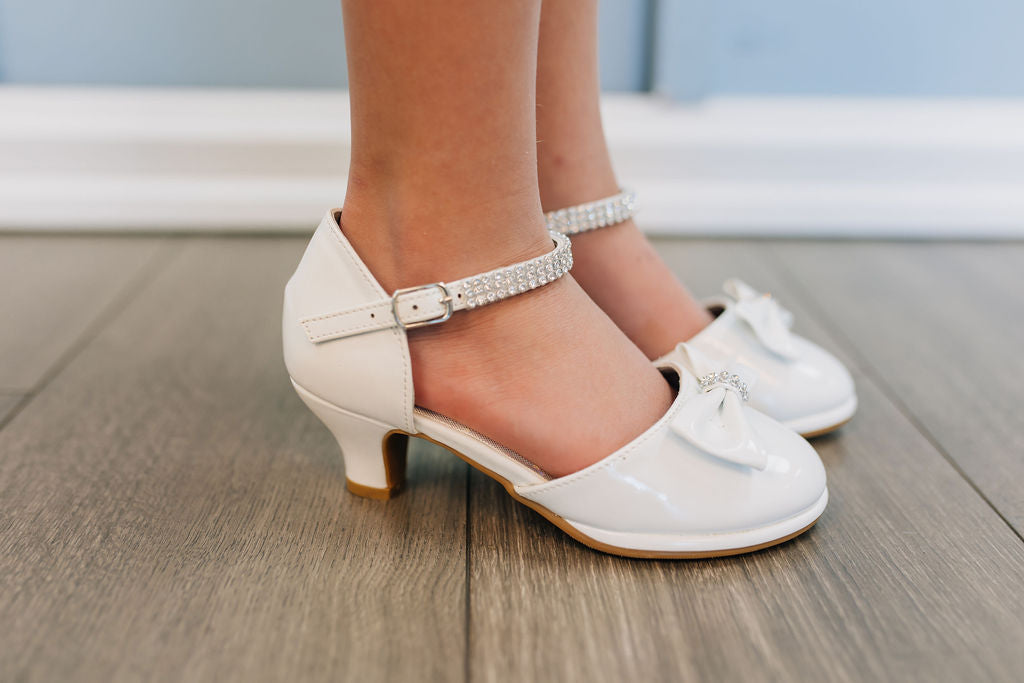white girls shoe with ankle strap and bow on toe