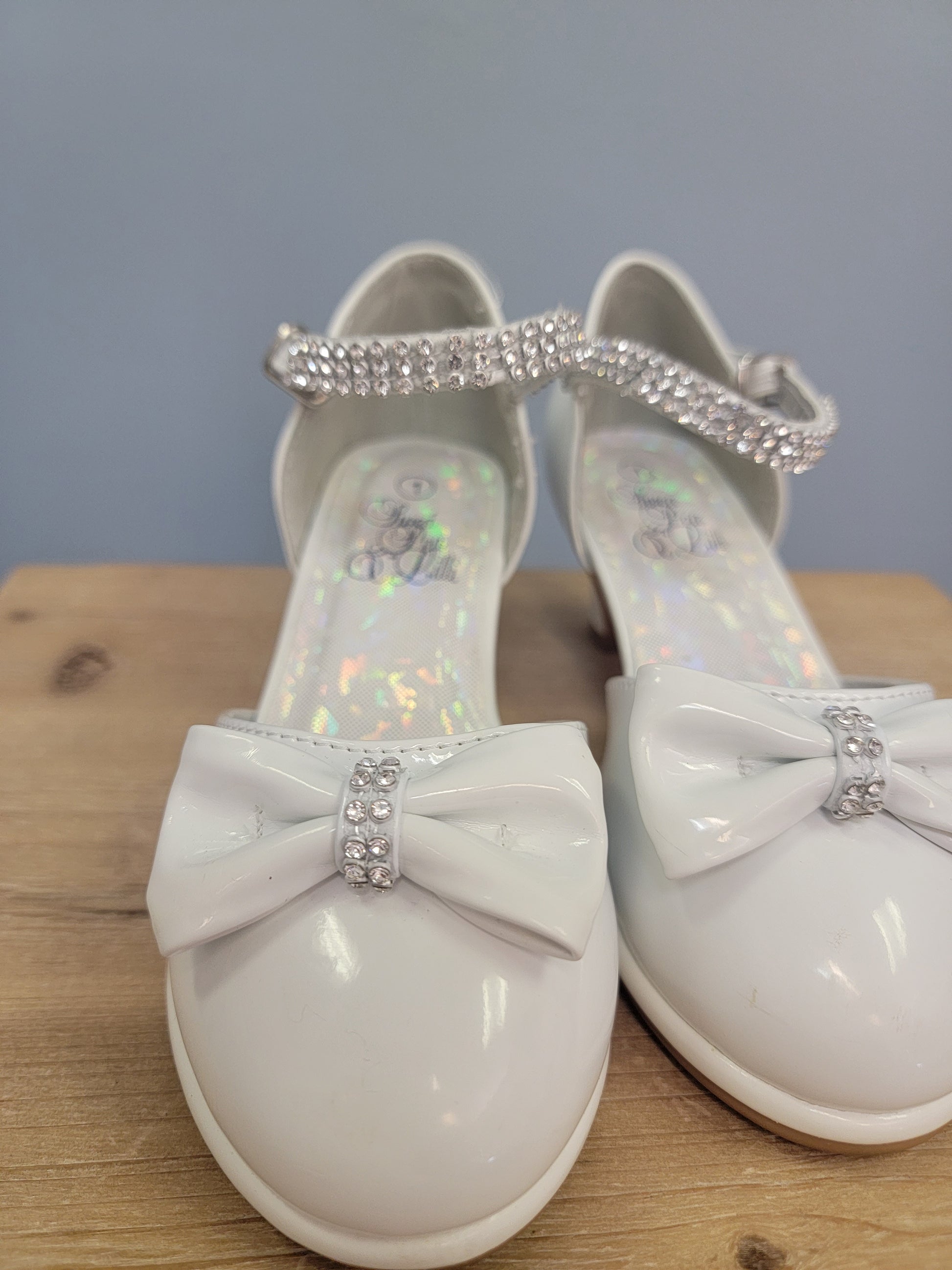 white girls shoe with ankle strap and bow on toe