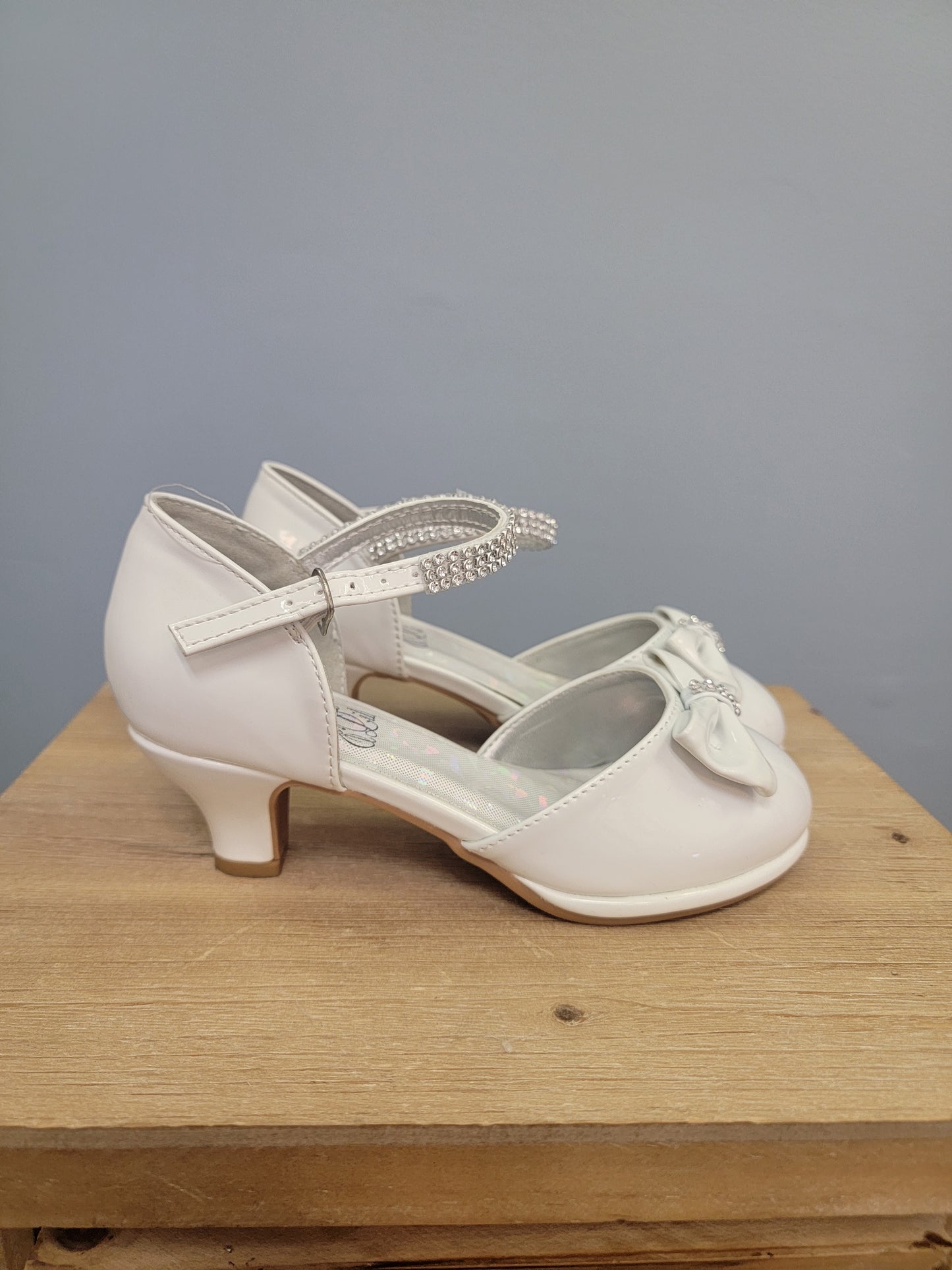 white girls shoe with ankle strap and bow on toe