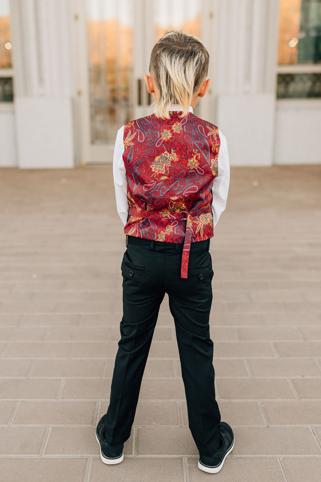 boy in black suit-back view