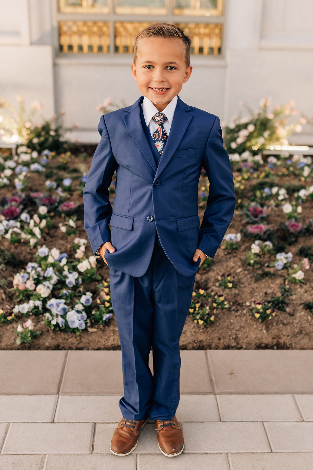 boy in blue suit and brown shoes
