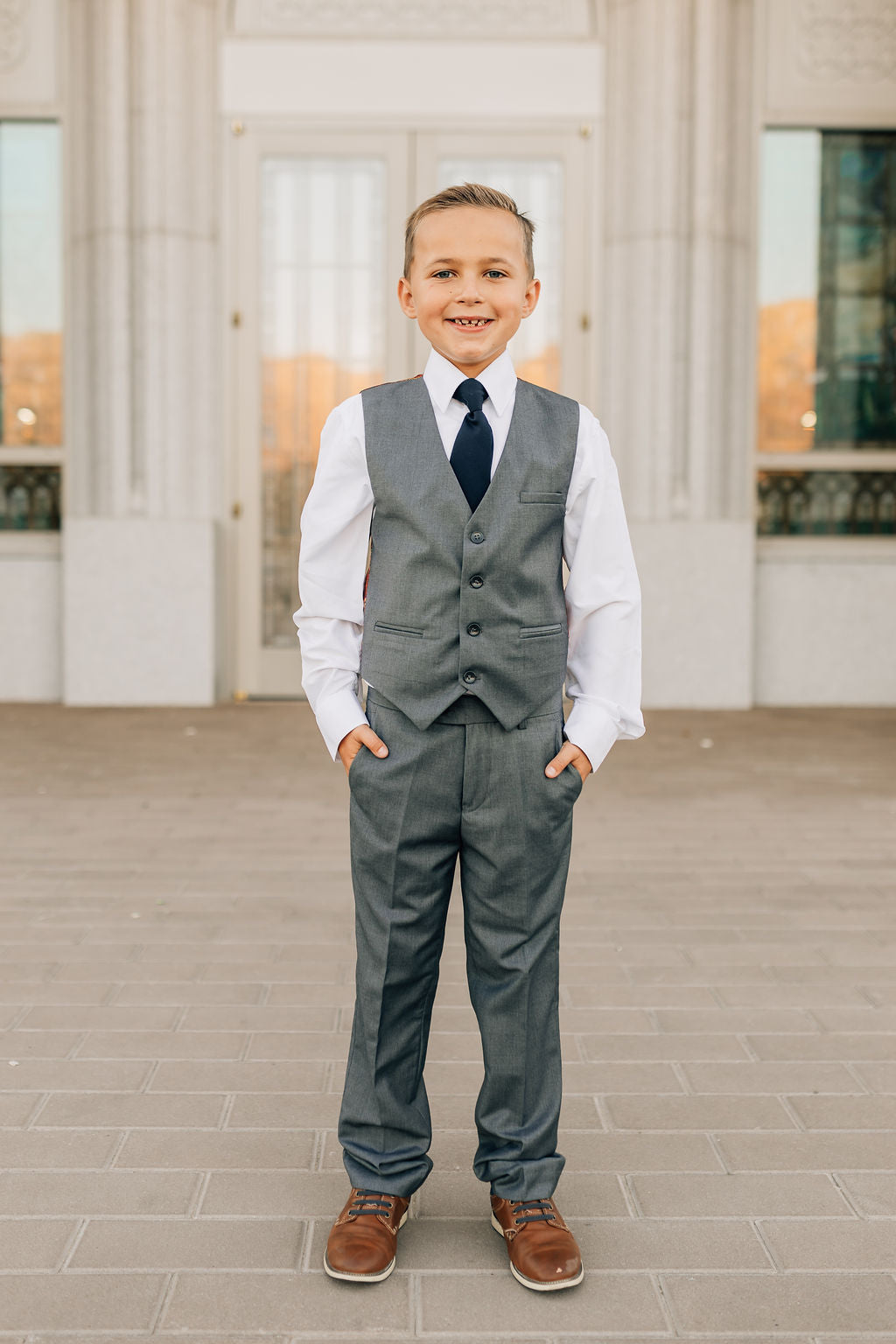 boy in charcoal dress pants and vest
