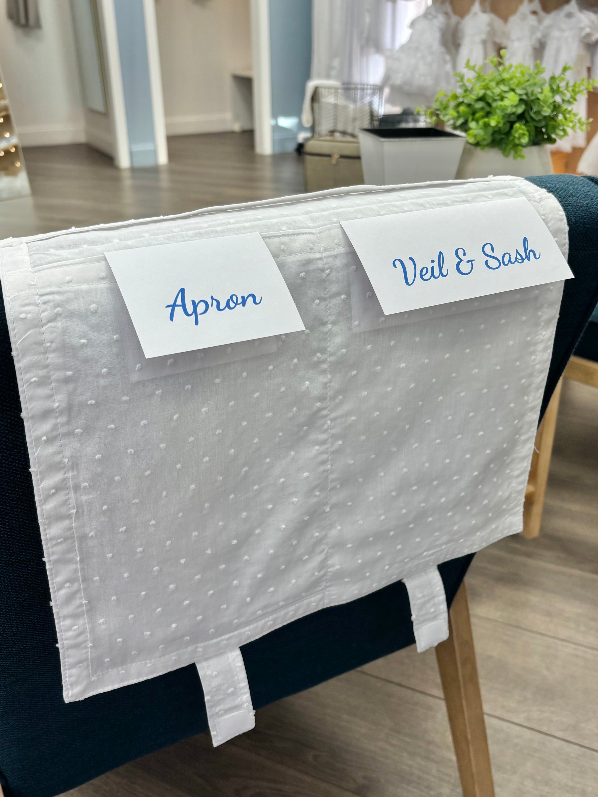 Cotton envelope draped over chair with labels.