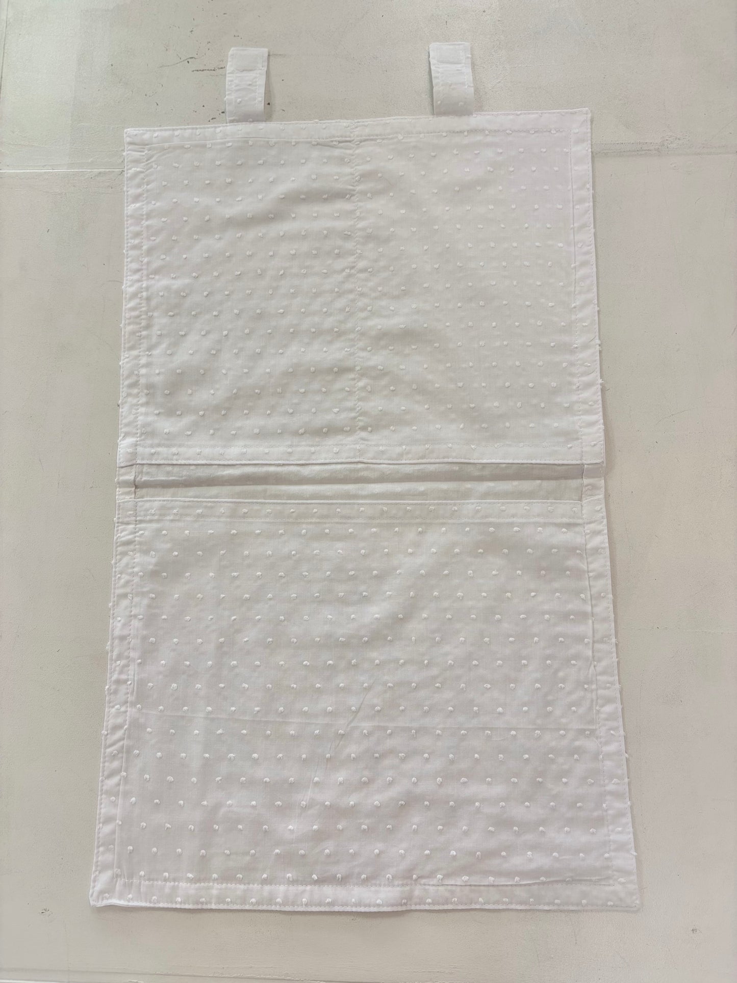 Open cotton envelope with pockets inside.
