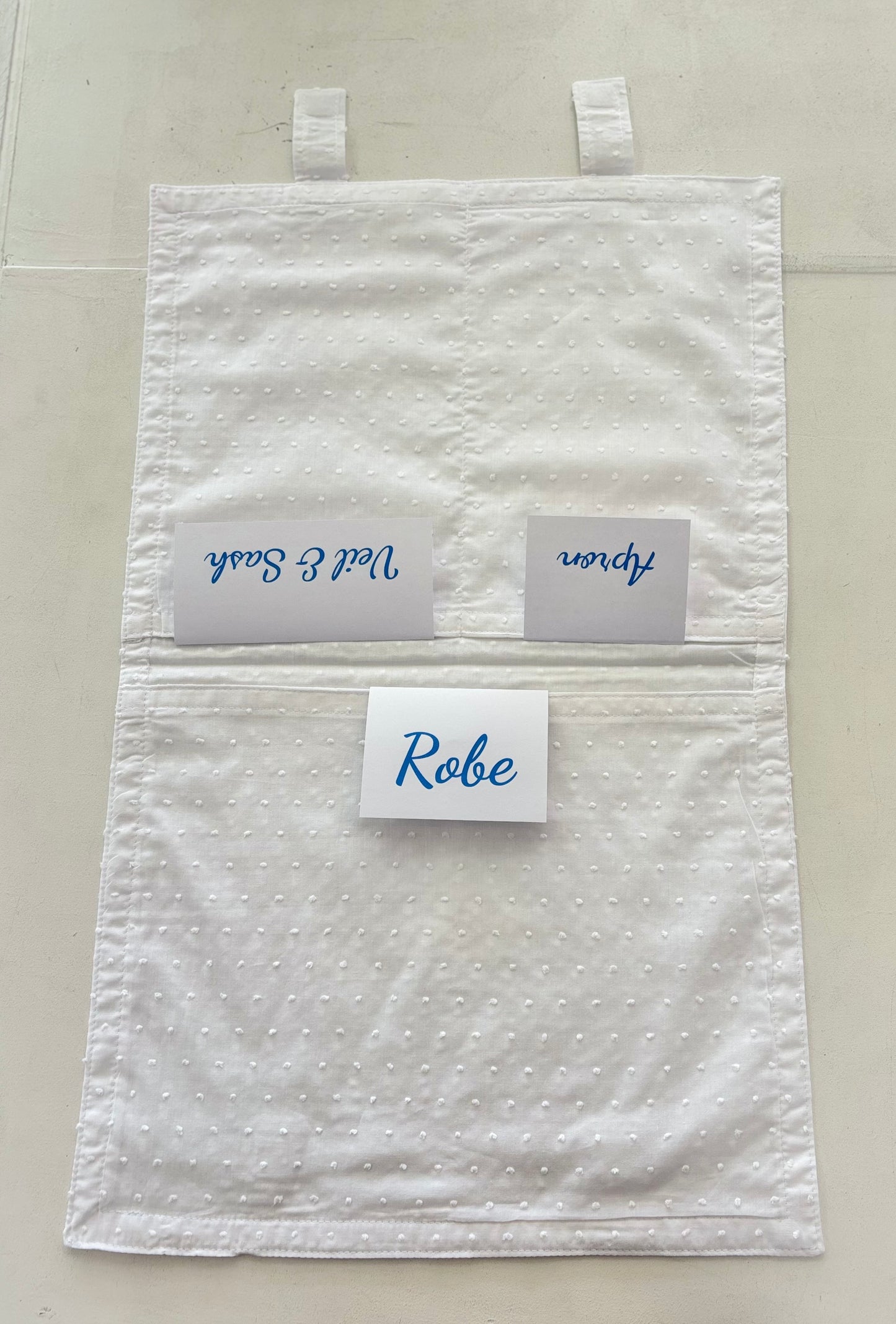 Open cotton envelope with labels in pockets.
