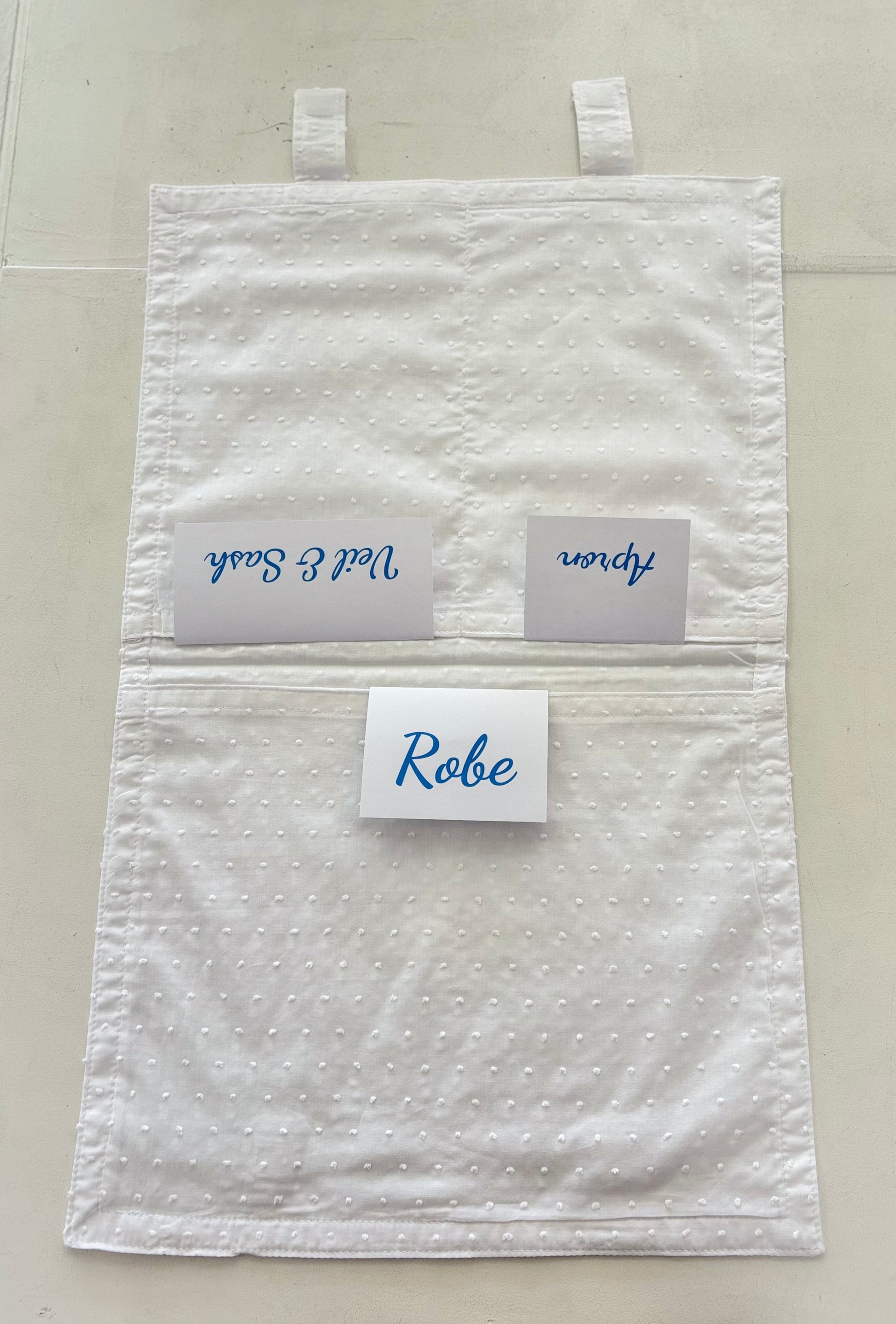 Open cotton envelope with labels in pockets.