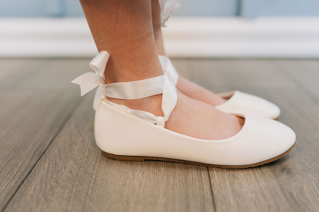 white ballerina flats with ribbon tie