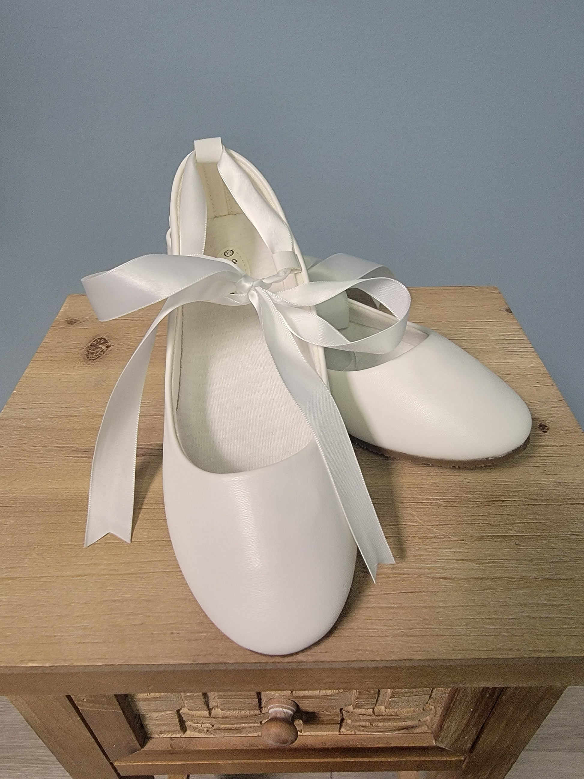 white ballerina flats with ribbon tie